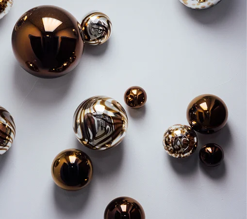 A minimalist, high-key background image featuring several translucent, teardrop-shaped glass light fixtures hanging at various heights.