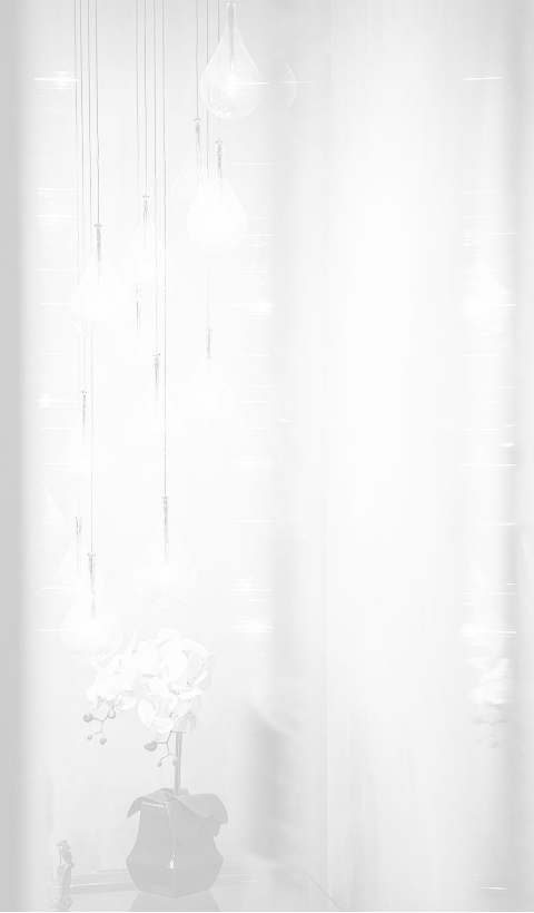 A minimalist, high-key background image featuring several translucent, teardrop-shaped glass light fixtures hanging at various heights.